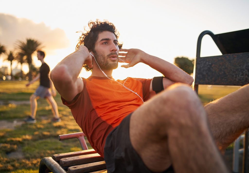man exercising in outdoor gym condominium